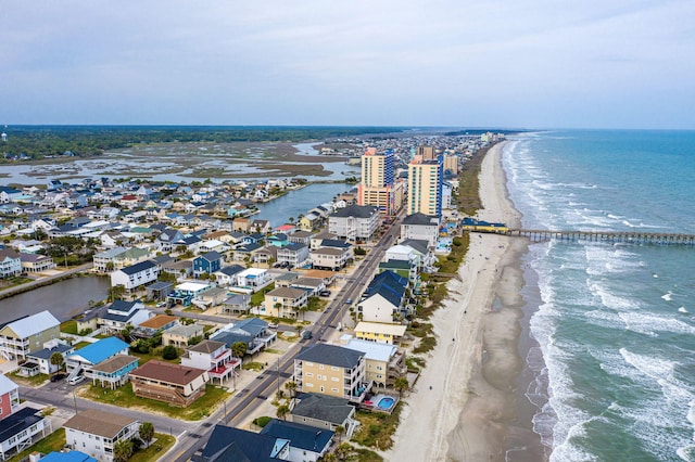 birds eye view of property with a beach view and a water view