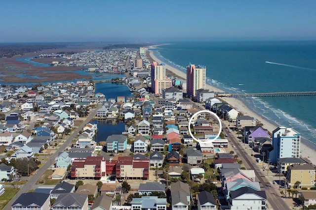 birds eye view of property with a water view and a view of the beach