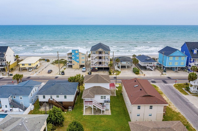 drone / aerial view with a residential view, a view of the beach, and a water view