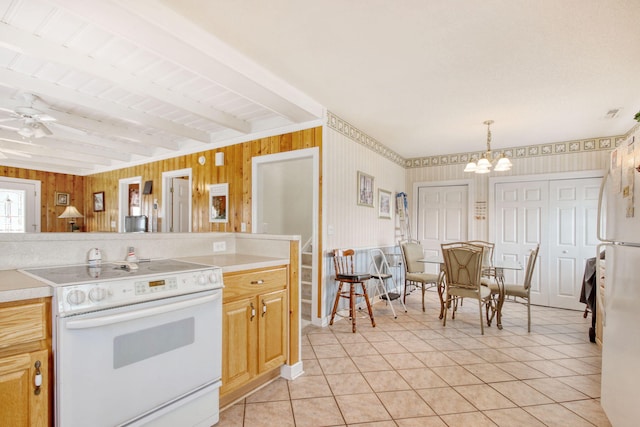 kitchen featuring white appliances, light tile patterned floors, beam ceiling, and light countertops