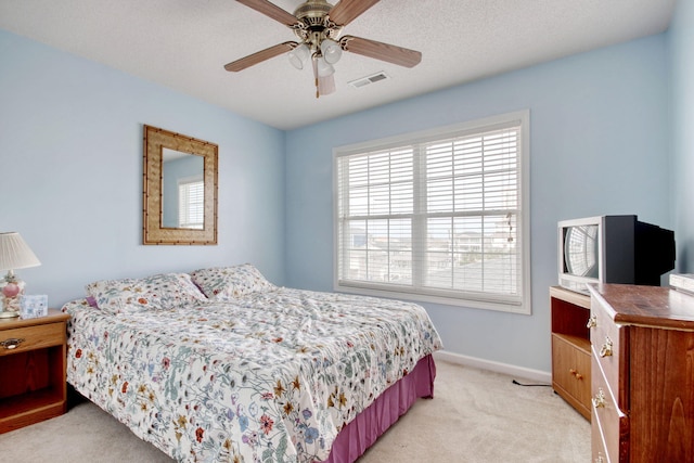 bedroom featuring baseboards, a ceiling fan, light colored carpet, and visible vents