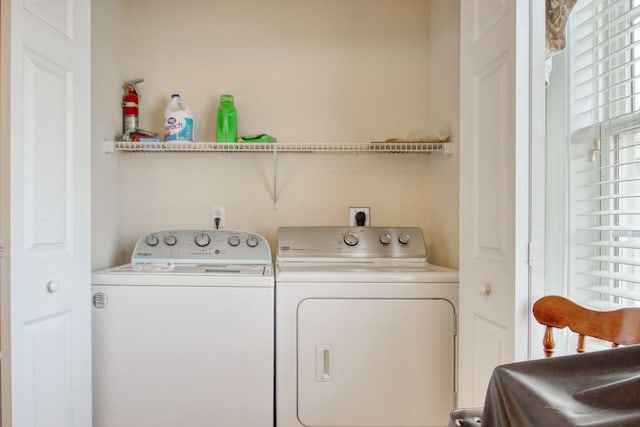 clothes washing area with independent washer and dryer and laundry area