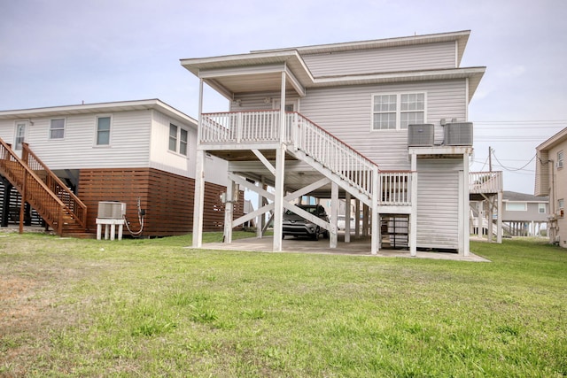 back of house featuring stairs, central air condition unit, and a yard