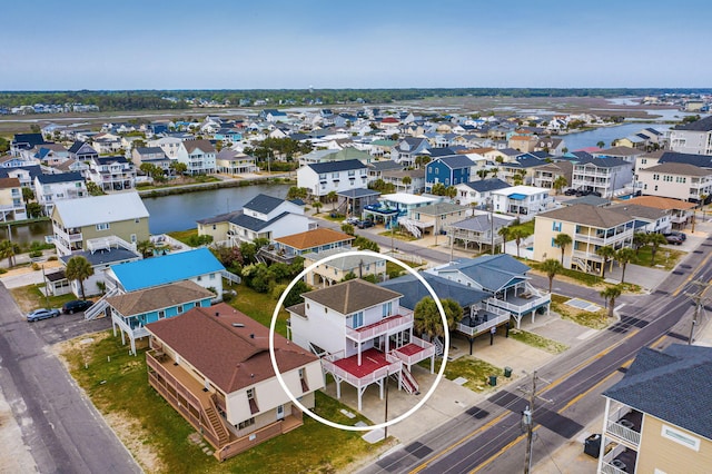 birds eye view of property with a water view and a residential view