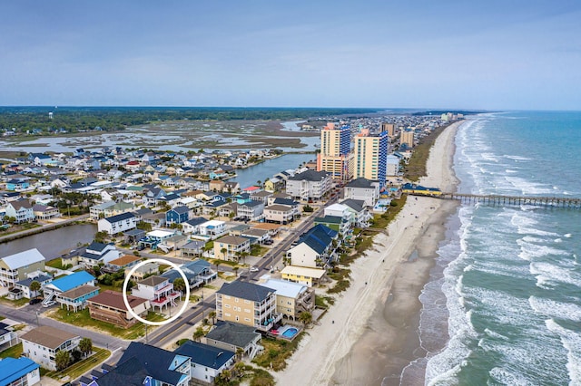 birds eye view of property with a beach view and a water view