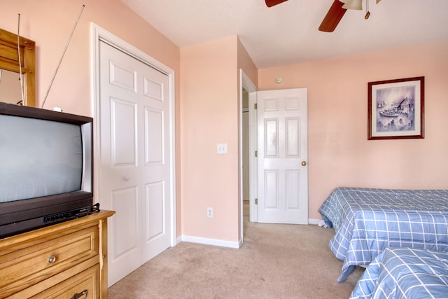 bedroom with baseboards, ceiling fan, and light colored carpet