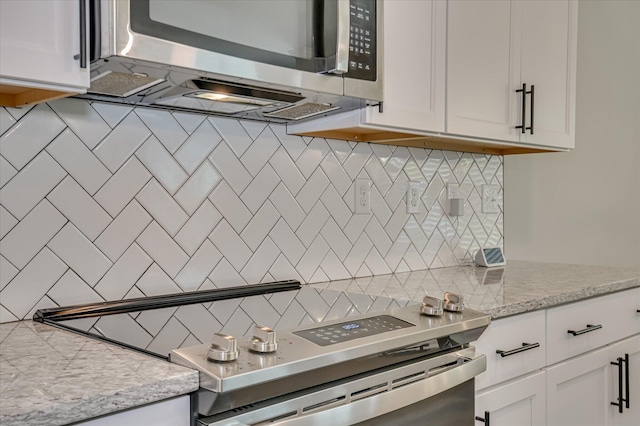 5265 Greyton Cir, North Augusta, SC 29860 - kitchen featuring appliances with stainless steel finishes, tasteful backsplash, and white cabinetry