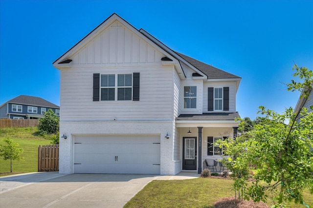 5265 Greyton Cir, North Augusta, SC 29860 - view of front of house with an attached garage, board and batten siding, driveway, a shingled roof, and brick siding