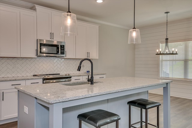 5265 Greyton Cir, North Augusta, SC 29860 - kitchen featuring appliances with stainless steel finishes, a sink, tasteful backsplash, dark wood finished floors, and crown molding