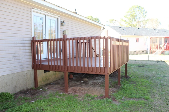 wooden deck with a lawn