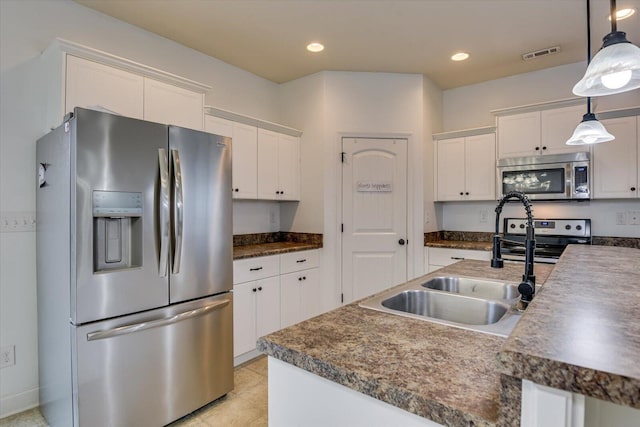 kitchen with white cabinetry, sink, pendant lighting, and stainless steel appliances