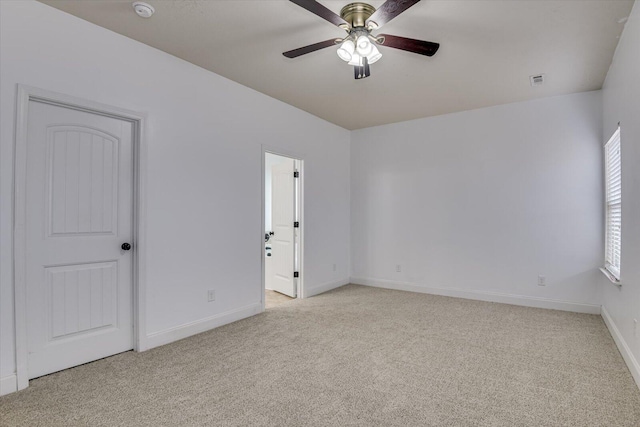 carpeted spare room featuring ceiling fan