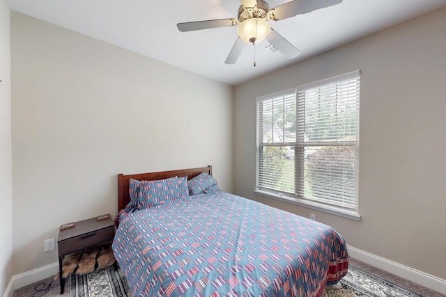 carpeted bedroom featuring baseboards and ceiling fan
