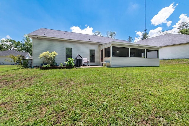 back of house with a sunroom, a yard, and a patio