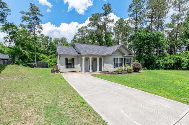 ranch-style house with driveway, a porch, and roof with shingles