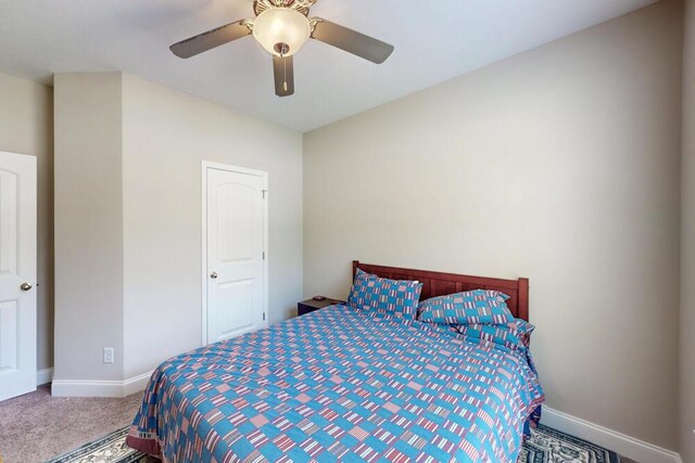 bedroom with carpet, baseboards, and ceiling fan