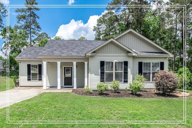 view of front of home with a porch, a front yard, board and batten siding, a shingled roof, and driveway