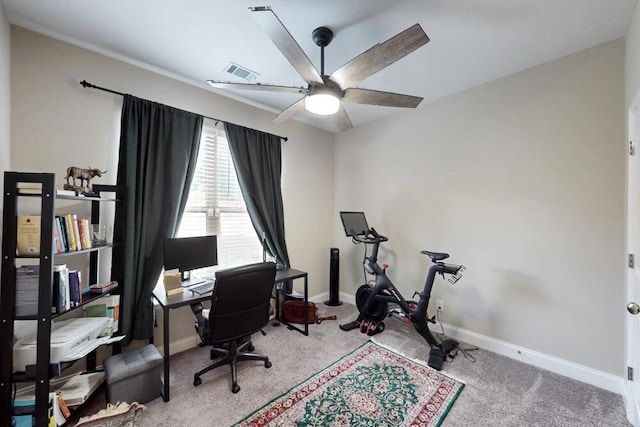 carpeted office with baseboards and a ceiling fan