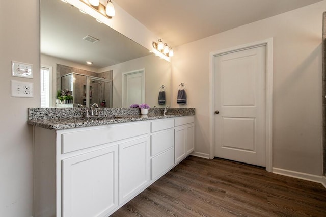 6134 High Top Ln, Aiken, SC 29801 - bathroom featuring a shower stall, double vanity, wood finished floors, and baseboards