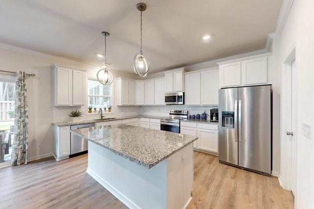 6134 High Top Ln, Aiken, SC 29801 - kitchen with stainless steel appliances, a sink, a kitchen island, ornamental molding, and white cabinetry