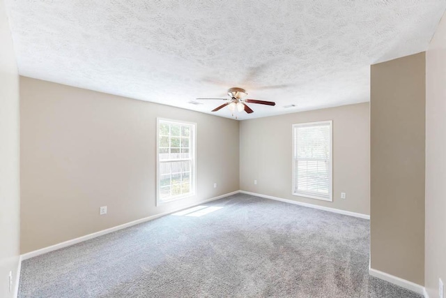 empty room with light carpet, a textured ceiling, and ceiling fan