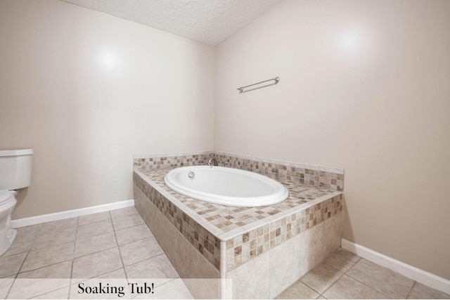 bathroom with tiled tub, a textured ceiling, tile patterned floors, and toilet