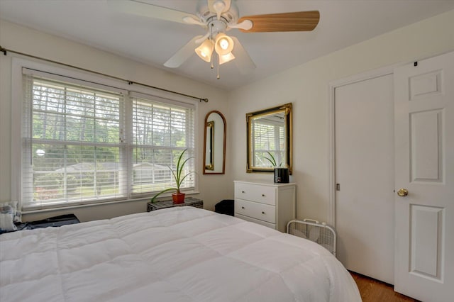 bedroom with a ceiling fan and wood finished floors
