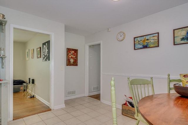 dining space with light tile patterned floors, baseboards, and visible vents