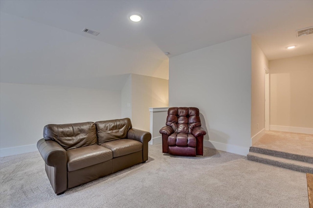 carpeted living room featuring lofted ceiling