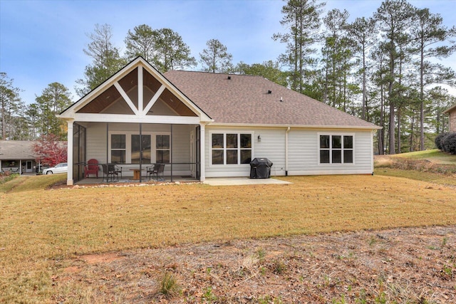 back of house with a sunroom, a yard, and a patio