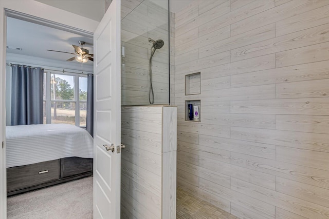 bathroom with ceiling fan, wood walls, and walk in shower