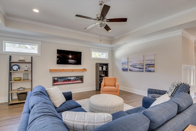 living room with ceiling fan, wood-type flooring, and ornamental molding