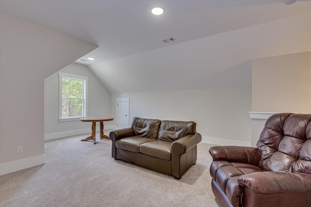 carpeted living room featuring vaulted ceiling