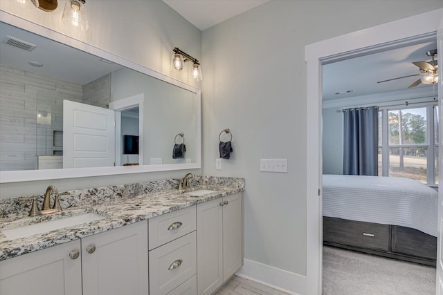 bathroom featuring vanity, ceiling fan, and a shower with shower door