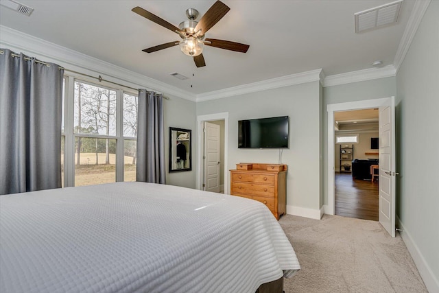 carpeted bedroom featuring ceiling fan and ornamental molding