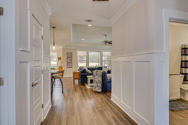 interior space with hardwood / wood-style floors and crown molding