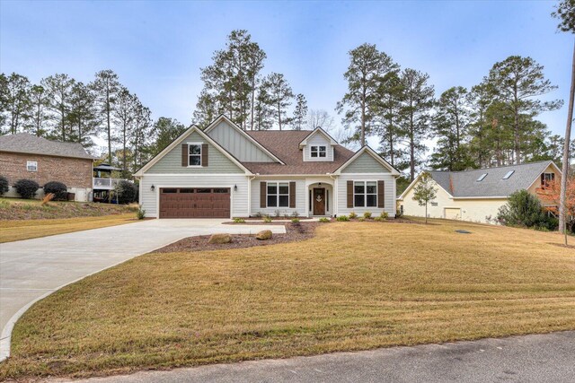 craftsman house with a front yard and a garage