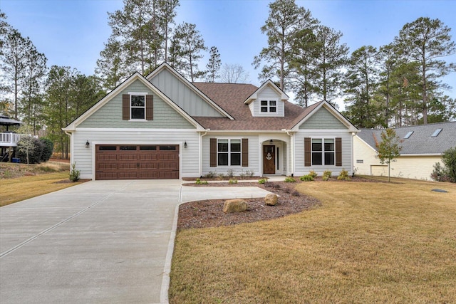 view of front of home with a garage and a front lawn