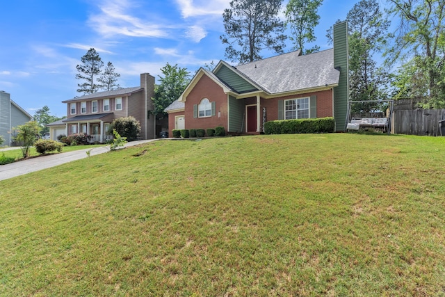 view of front of property with brick siding, driveway, and a chimney