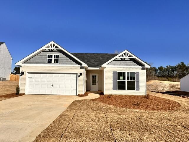 craftsman house with a garage and a front yard