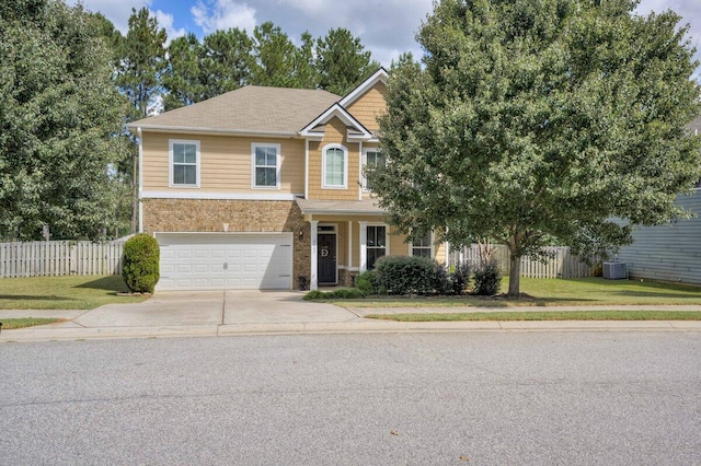 view of front of home with a front yard and a garage