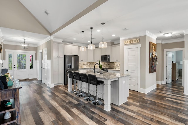 134 Twelve Oaks Dr, Mccormick, SC 29835 - kitchen with visible vents, black microwave, light stone countertops, a breakfast bar area, and high end refrigerator