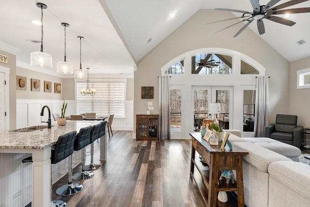 134 Twelve Oaks Dr, Mccormick, SC 29835 - living room featuring dark wood finished floors, ceiling fan with notable chandelier, visible vents, and a healthy amount of sunlight