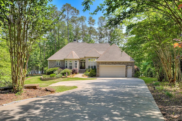 209 Apple Ln, Mccormick, SC 29835 - view of front facade featuring concrete driveway, a garage, roof with shingles, and a chimney