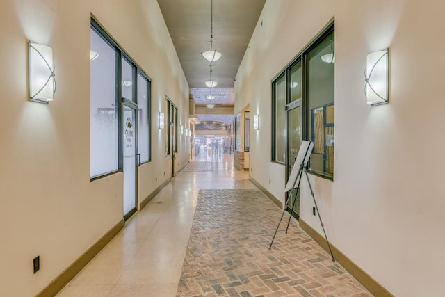 hall featuring a towering ceiling