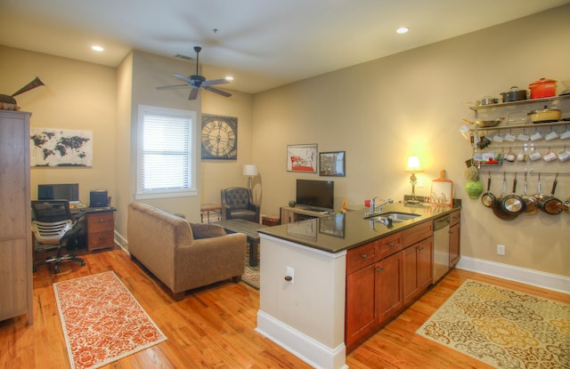 office space featuring sink, light hardwood / wood-style flooring, and ceiling fan