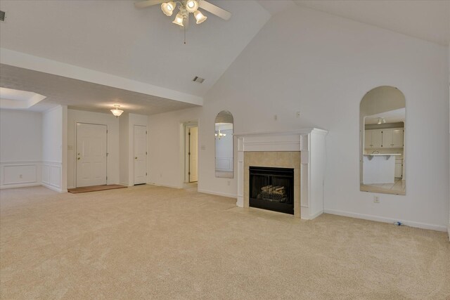 1008 Storey Mill Ct, Hephzibah, GA 30815 - unfurnished living room featuring a ceiling fan, light carpet, high vaulted ceiling, a tile fireplace, and arched walkways