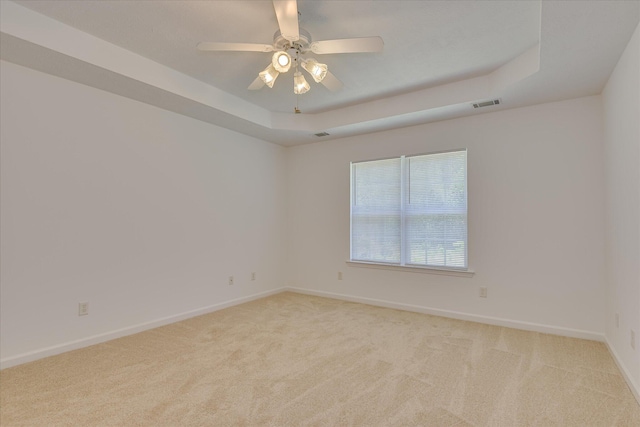 1008 Storey Mill Ct, Hephzibah, GA 30815 - unfurnished room featuring a tray ceiling, light colored carpet, and a ceiling fan