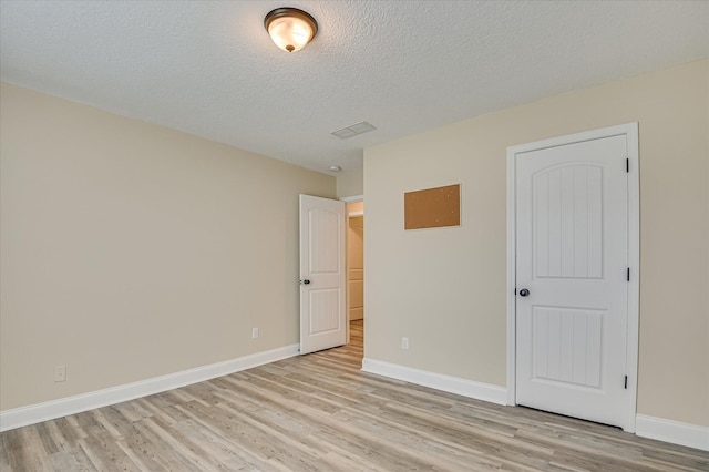 2030 Lake Forest Dr, Grovetown, GA 30813 - unfurnished bedroom with light wood-type flooring and a textured ceiling