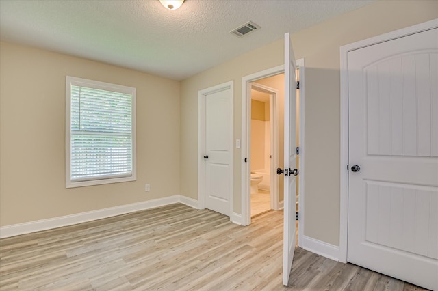 2030 Lake Forest Dr, Grovetown, GA 30813 - unfurnished bedroom featuring light wood-type flooring and a textured ceiling